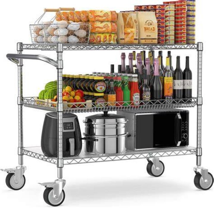 A bar cart packed with bottles and decor