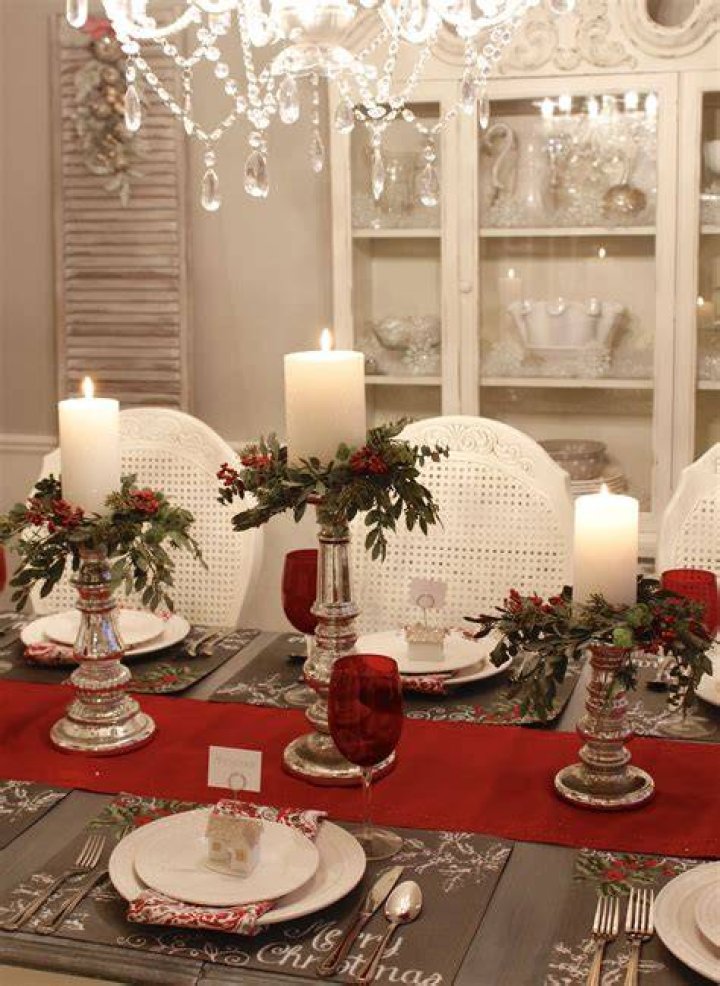 A dining room table decorated with candles and spooky decor