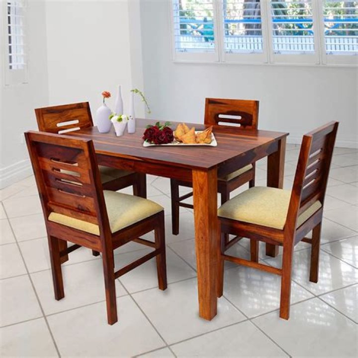 A dining table set with plates, food, and wine