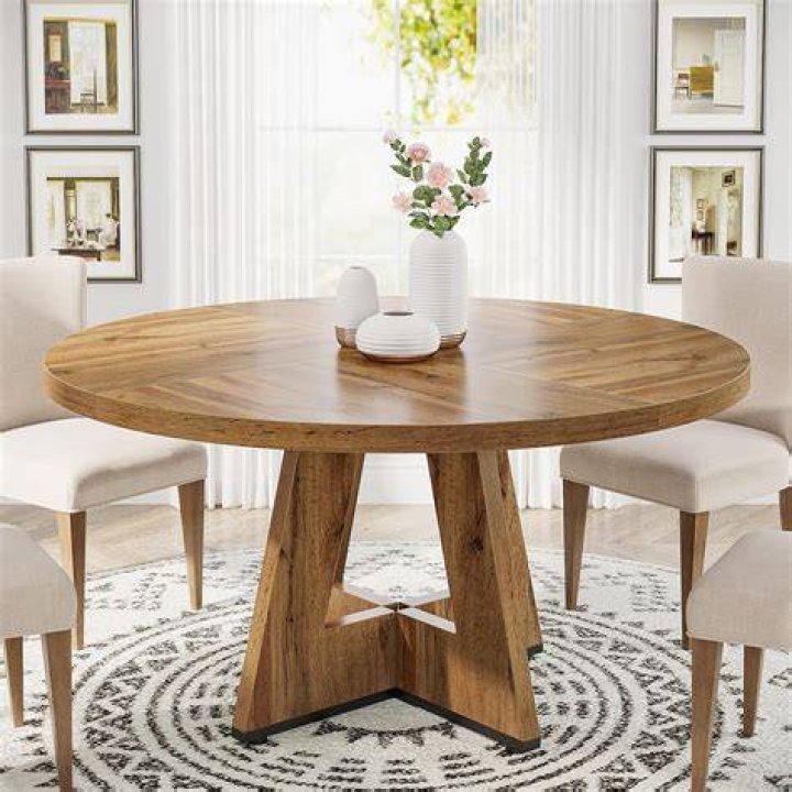 A dining table topped with a burlap table runner and rustic dinnerware