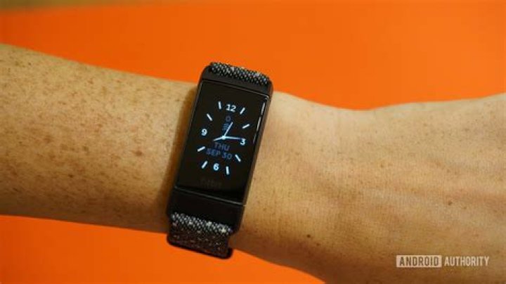A Fitbit Charge 4 displays its 4 digit pairing code while a Galaxy A51 pairs to the device.