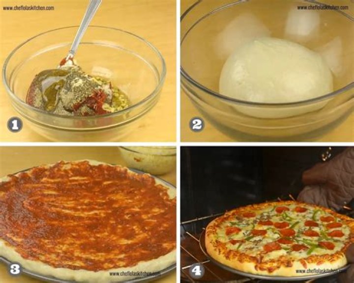 A homemade pizza being placed in a pizza oven