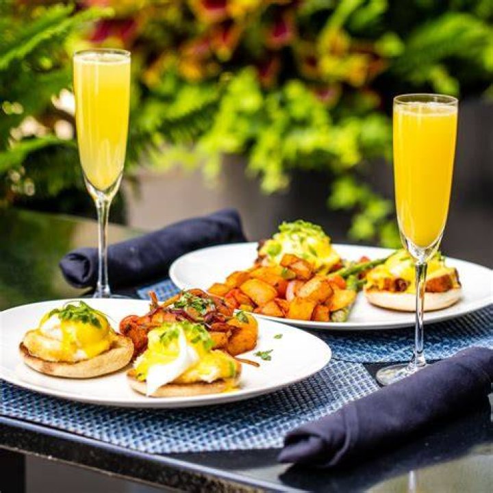 A mimosa buffet with juice, champagne, and fresh fruit