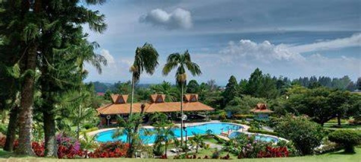 A resort with a pool and a beachfront view
