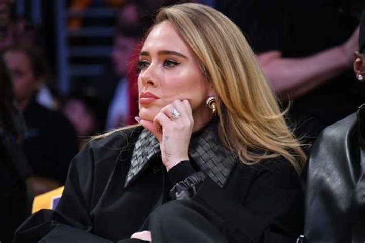 Adele covering her face