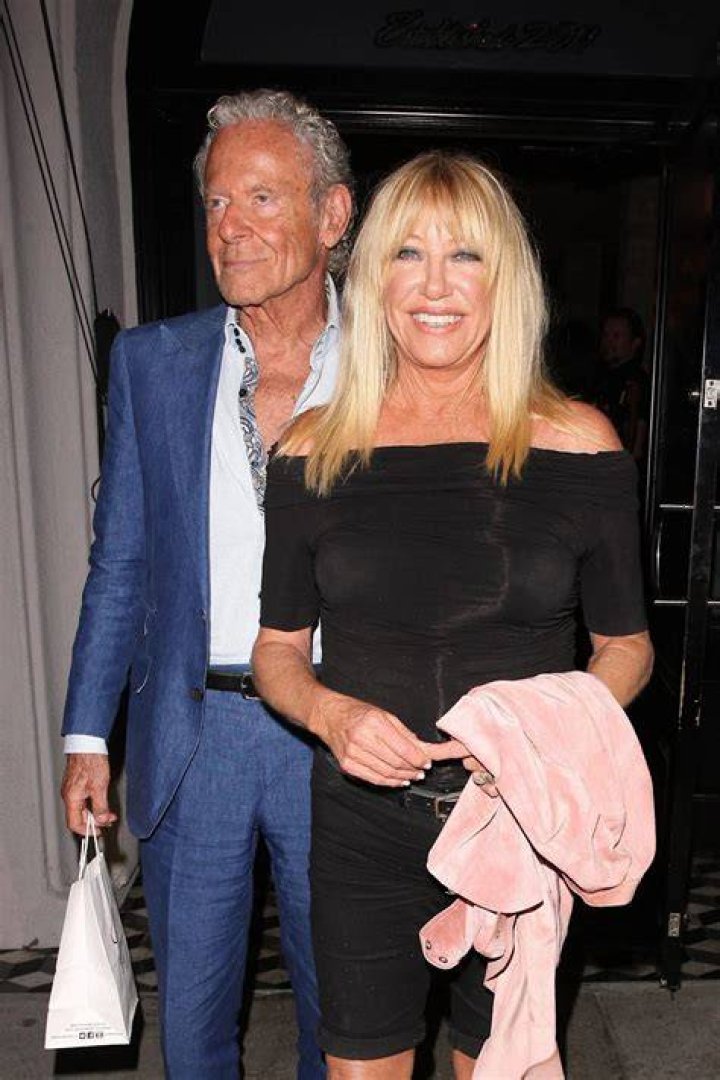 Alan Hamel giving Suzanne Somers a kiss on the head from behind.