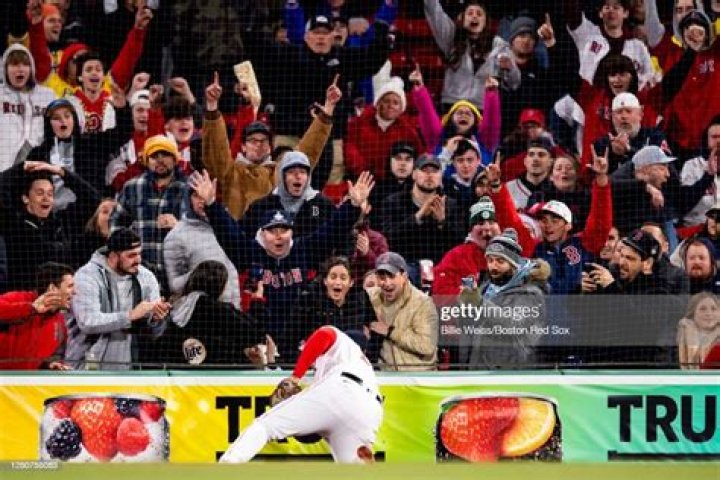 BOSTON, MA - APRIL 3: Rob Gronkowski #87 and Tom Brady #12 of the New England Patriots enter the field carrying Vince Lombardi trophies before the opening day game between the Boston Red Sox and the Pittsburgh Pirates at Fenway Park on April 3, 2017 in Boston, Massachusetts. (Photo by Maddie Meyer/Getty Images)