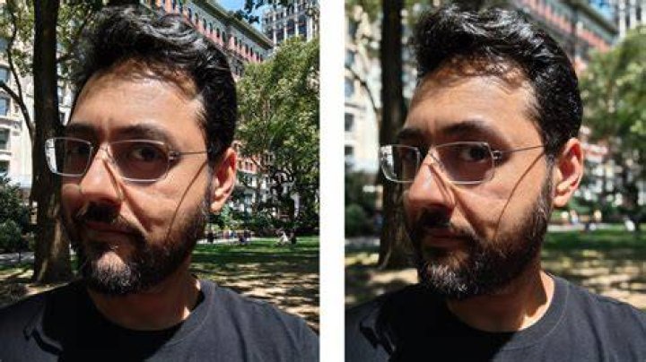 Camera sample selfie outdoor portrait shot of a man with dark hair and facial hair wearing a beige jacket, with headphones around his neck, taken on the Google Pixel 6 Pro