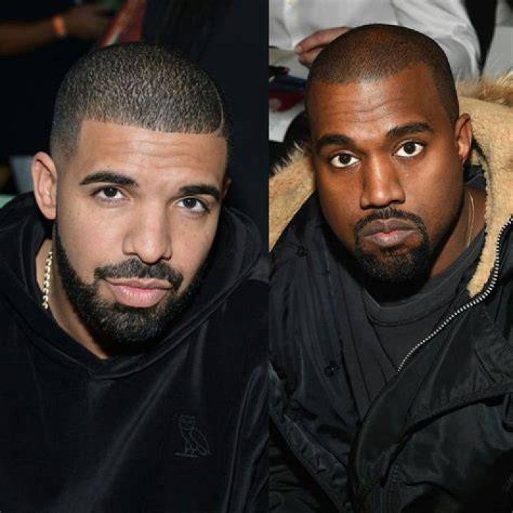 drake and kanye at a concert high fiving on stage