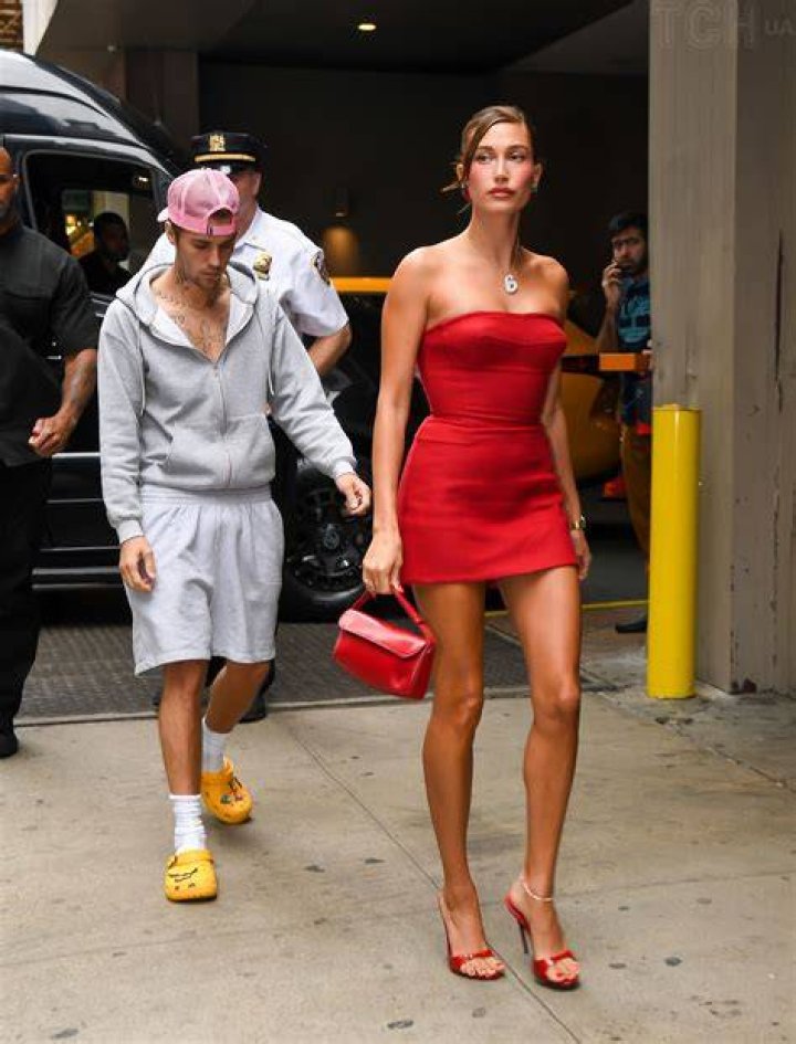 Hailey Bieber looking serious with sunglasses on and brown hair