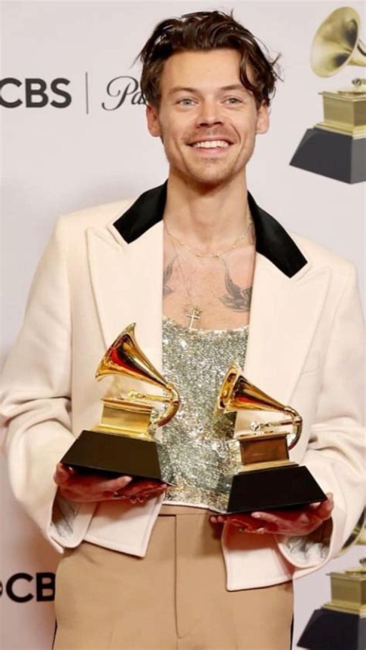 Harry Styles holding Grammys