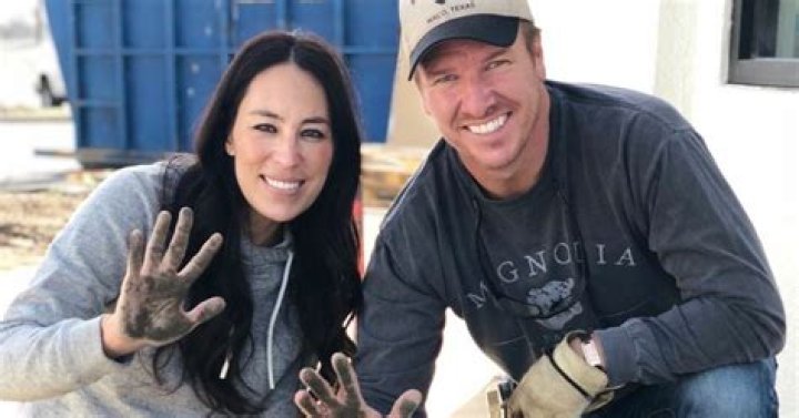 Joanna and Chip Gaines smiling with muddy hands
