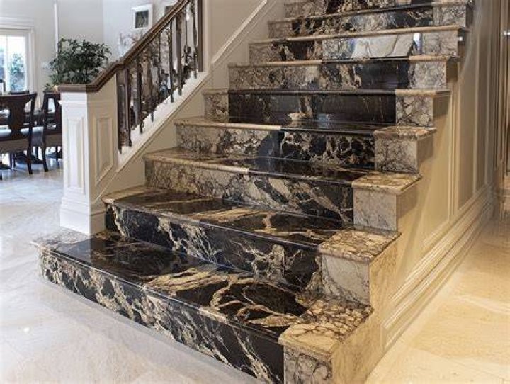 Marble stairs lined with a red carpet
