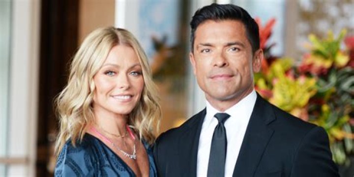 Mark Consuelos posing with the Collins twins