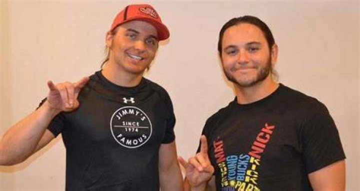 Nick and Matt Jackson and Matt and Jeff Hardy surrounded by ladders in a wrestling ring