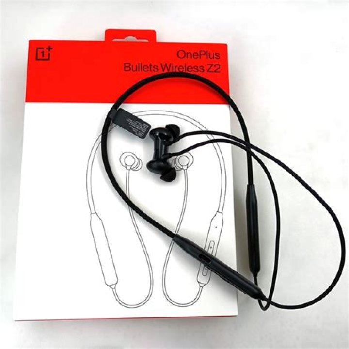 OnePlus Bullets Wireless 2: The old Bullets Wireless on the left and new on the right. They're sitting on the red carrying pouch.
