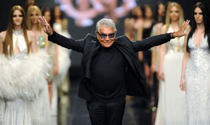 Roberto Cavalli walking on the beach wearing a black swimsuit and holding a pack of cigarretes. Pictured: Roberto Cavalli Ref: SPL56341 191008 Picture by: Splash News Splash News and Pictures Los Angeles: 310-821-2666 New York: 212-619-2666 London: 870-934-2666 
