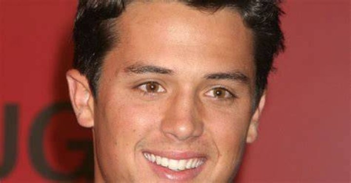 Stephen Colletti smiling against a red background