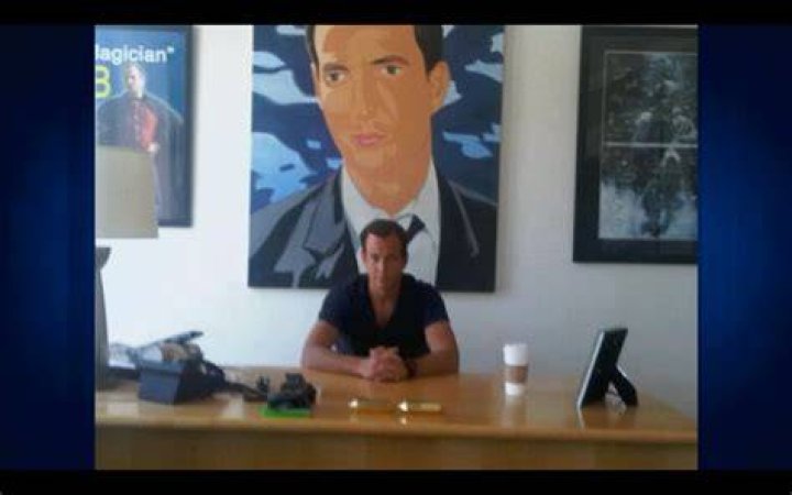 Will Arnett sits in front of his self portrait