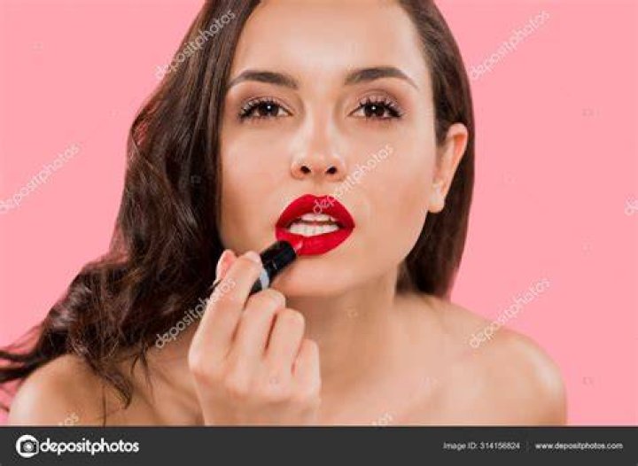 Woman applying lipstick